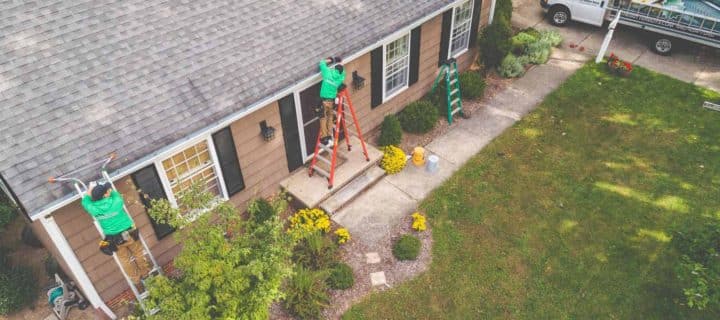 aerial view of The Gutter Boys technicians using ladders to clean gutters